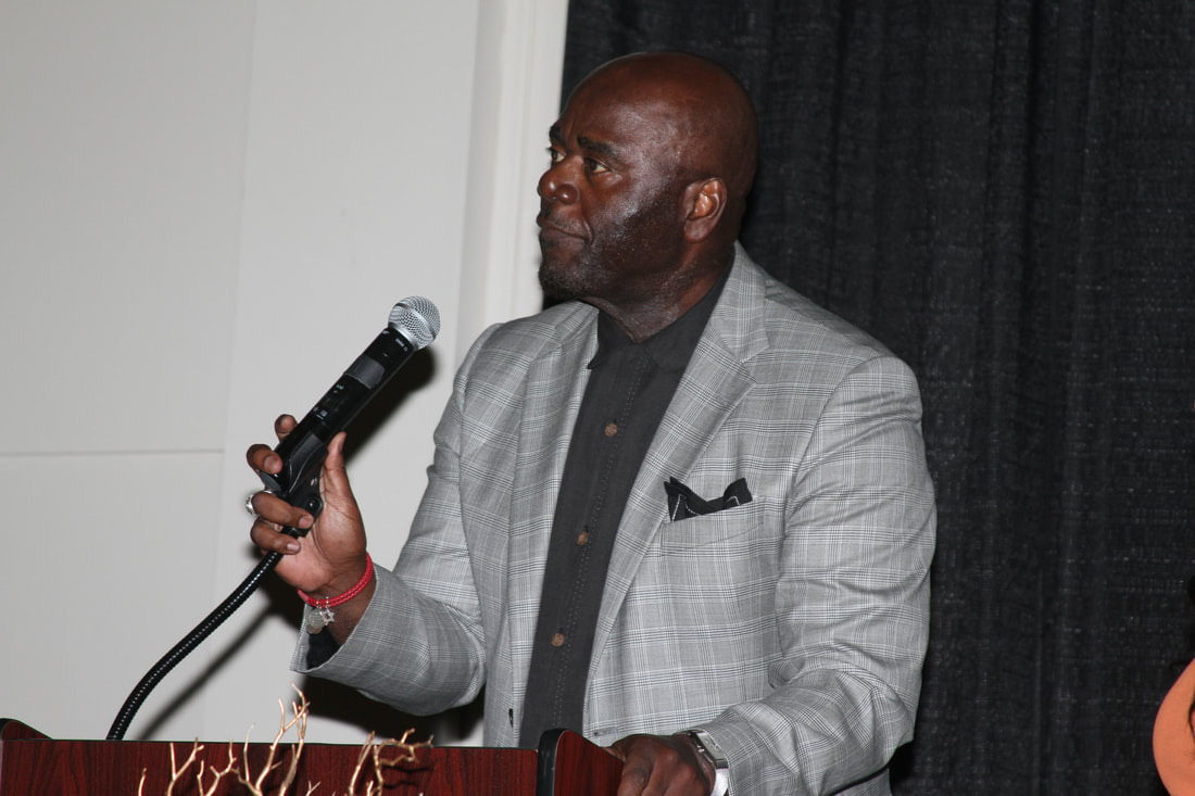 Cleophus P. Franklin Jr. speaking from a podium, microphone in hand